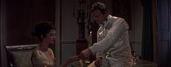 Movie still from “Désirée” (1954), directed by Henry Koster – A man and a woman are holding a knife; Medium shot, High angle