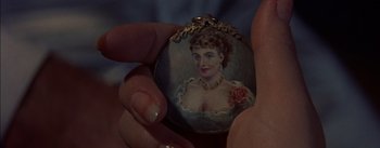 Movie still from “Désirée” (1954), directed by Henry Koster – A person holding a painting of a woman; Extreme Close Up shot, Overhead angle