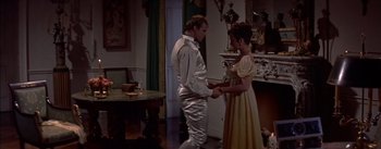 Movie still from “Désirée” (1954), directed by Henry Koster – A man and a woman dressed in silver holding hands; Medium shot, High angle