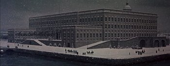 Movie still from “Désirée” (1954), directed by Henry Koster – An old photo of a large building in the snow; Extreme Wide shot, High angle