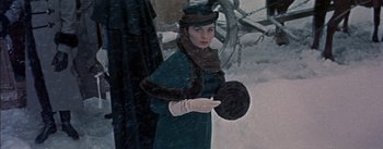 Movie still from “Désirée” (1954), directed by Henry Koster – A woman wearing a hat and gloves in the snow; Close Up shot, Over the shoulder angle