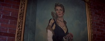 Movie still from “Désirée” (1954), directed by Henry Koster – An older woman wearing a crown and holding a bouquet of flowers; Close Up shot, Low angle