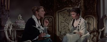 Movie still from “Désirée” (1954), directed by Henry Koster – Two women are sitting in a room and one of them is eating; Medium shot, Over the shoulder angle