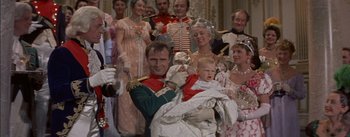 Movie still from “Désirée” (1954), directed by Henry Koster – A group of people dressed up in costumes; Medium shot, High angle