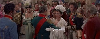 Movie still from “Désirée” (1954), directed by Henry Koster – A man and a woman dressed in period costumes; Medium shot, Over the shoulder angle