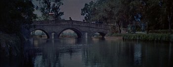 Movie still from “Désirée” (1954), directed by Henry Koster – A bridge over a body of water at night time; Extreme Wide shot, High angle