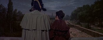 Movie still from “Désirée” (1954), directed by Henry Koster – A man and a woman standing next to each other; Medium shot, High angle