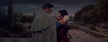 Movie still from “Désirée” (1954), directed by Henry Koster – A man and a woman that are standing together; Medium shot, Low angle