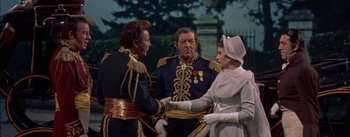 Movie still from “Désirée” (1954), directed by Henry Koster – A group of people standing next to each other; Medium shot, Over the shoulder angle