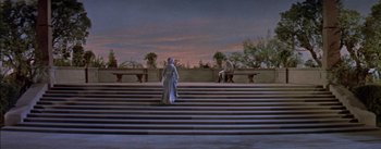 Movie still from “Désirée” (1954), directed by Henry Koster – A statue of a person standing on a set of stairs; Extreme Wide shot, High angle