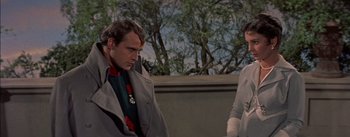 Movie still from “Désirée” (1954), directed by Henry Koster – A man and a woman sitting next to each other on a bench; Medium shot, Over the shoulder angle