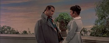 Movie still from “Désirée” (1954), directed by Henry Koster – A man and a woman standing next to each other; Medium shot, Low angle