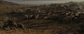 Movie still from “Eagle Eye” (2008), directed by D.J. Caruso – An aerial view of an abandoned town with smoke coming out of the chimney; Extreme Wide shot, High angle
