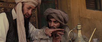 Movie still from “Eagle Eye” (2008), directed by D.J. Caruso – A man in a turban pointing to his face; Medium shot, Over the shoulder angle