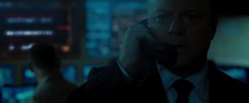 Movie still from “Eagle Eye” (2008), directed by D.J. Caruso – A man in a suit talking on a phone; Close Up shot, Over the shoulder angle