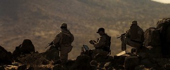 Movie still from “Eagle Eye” (2008), directed by D.J. Caruso – Two men sitting on top of a rock formation; Wide shot, Low angle