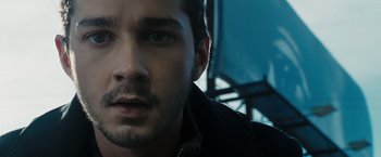 Movie still from “Eagle Eye” (2008), directed by D.J. Caruso – A man's face in a dark room; Close Up shot, Low angle