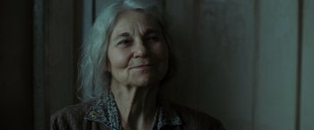 Movie still from “Eagle Eye” (2008), directed by D.J. Caruso – An older woman is looking at the camera; Close Up shot, Low angle