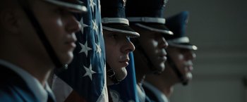 Movie still from “Eagle Eye” (2008), directed by D.J. Caruso – A group of men standing next to each other in uniforms; Close Up shot, Low angle