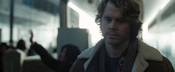 Movie still from “Eagle Eye” (2008), directed by D.J. Caruso – A person wearing a jacket on a train; Close Up shot, Over the shoulder angle