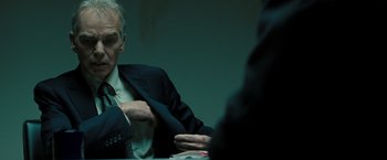 Movie still from “Eagle Eye” (2008), directed by D.J. Caruso – A man sitting at a table in front of another man; Close Up shot, Over the shoulder angle