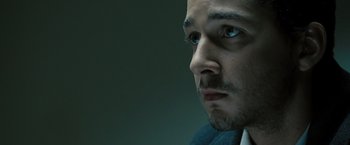 Movie still from “Eagle Eye” (2008), directed by D.J. Caruso – A person with a beard looking to his left; Close Up shot, Low angle