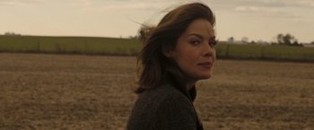 Movie still from “Eagle Eye” (2008), directed by D.J. Caruso – A person in a field; Close Up shot, Over the shoulder angle