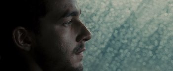 Movie still from “Eagle Eye” (2008), directed by D.J. Caruso – A man's face with a blurry background; Extreme Close Up shot, Low angle