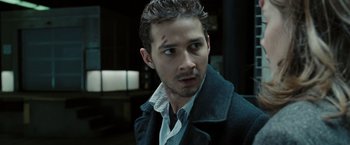 Movie still from “Eagle Eye” (2008), directed by D.J. Caruso – A person wearing a jacket; Close Up shot, Over the shoulder angle