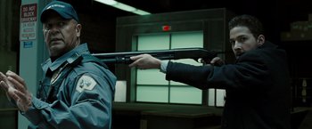 Movie still from “Eagle Eye” (2008), directed by D.J. Caruso – A man holding a gun pointed at another man's face; Medium shot, Over the shoulder angle