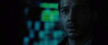 Movie still from “Eagle Eye” (2008), directed by D.J. Caruso – A person looking at the camera; Close Up shot, Over the shoulder angle