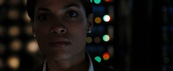 Movie still from “Eagle Eye” (2008), directed by D.J. Caruso – A woman's face in front of a city skyline at night; Close Up shot, Low angle