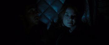 Movie still from “Eagle Eye” (2008), directed by D.J. Caruso – A man and a woman sitting in a dark room at night; Close Up shot, Low angle
