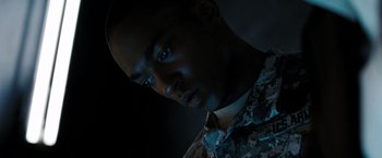 Movie still from “Eagle Eye” (2008), directed by D.J. Caruso – A man in a military fatigues looking into the camera; Close Up shot, Low angle