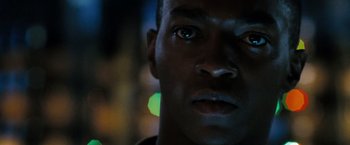 Movie still from “Eagle Eye” (2008), directed by D.J. Caruso – A man's face in the dark; Extreme Close Up shot, Over the shoulder angle