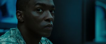 Movie still from “Eagle Eye” (2008), directed by D.J. Caruso – A man's face in the dark; Close Up shot, Low angle