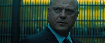 Movie still from “Eagle Eye” (2008), directed by D.J. Caruso – A person wearing a suit and tie; Close Up shot, Low angle