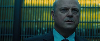 Movie still from “Eagle Eye” (2008), directed by D.J. Caruso – A person wearing a suit and tie; Close Up shot, Low angle