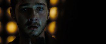 Movie still from “Eagle Eye” (2008), directed by D.J. Caruso – A person with a beard; Close Up shot, Over the shoulder angle