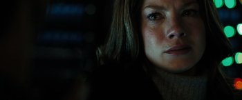 Movie still from “Eagle Eye” (2008), directed by D.J. Caruso – A woman's face in the dark; Close Up shot, Over the shoulder angle