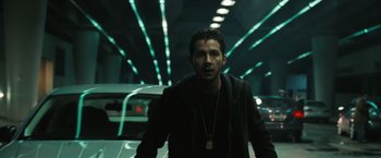 Movie still from “Eagle Eye” (2008), directed by D.J. Caruso – A man with a red spot on his forehead is standing in a tunnel; Medium shot, Low angle