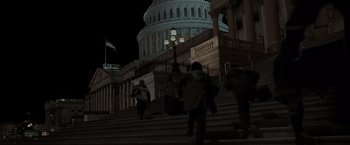 Movie still from “Eagle Eye” (2008), directed by D.J. Caruso – A group of people walking up the steps of the capitol building at night; Extreme Wide shot, Low angle