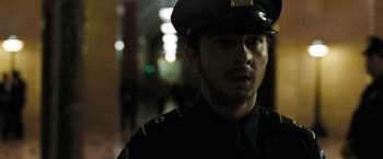 Movie still from “Eagle Eye” (2008), directed by D.J. Caruso – A man in a police uniform looking at the camera; Close Up shot, Low angle