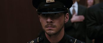 Movie still from “Eagle Eye” (2008), directed by D.J. Caruso – A man in a police officer's uniform with a mustache; Close Up shot, High angle