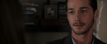 Movie still from “Eagle Eye” (2008), directed by D.J. Caruso – A person wearing a suit and tie; Close Up shot, Over the shoulder angle