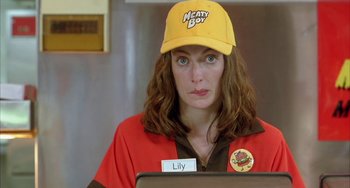Movie still from “Eagle vs Shark” (2007), directed by Taika Waititi – A woman wearing a hat and holding a name tag; Close Up shot, Low angle