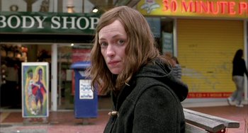 Movie still from “Eagle vs Shark” (2007), directed by Taika Waititi – A woman with long brown hair wearing a black jacket; Close Up shot, Over the shoulder angle