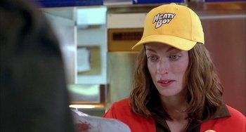 Movie still from “Eagle vs Shark” (2007), directed by Taika Waititi – A woman wearing a yellow hat sitting at a table; Close Up shot, Over the shoulder angle