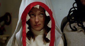 Movie still from “Eagle vs Shark” (2007), directed by Taika Waititi – A woman wearing a white and red hooded robe; Close Up shot, Low angle