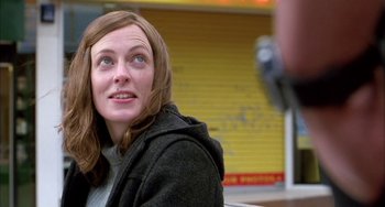 Movie still from “Eagle vs Shark” (2007), directed by Taika Waititi – A woman sitting in front of a yellow wall; Close Up shot, Low angle